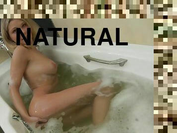 Maggie enjoys a bathing session while masturbating