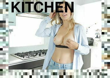 Beautiful blonde bombshell Ryan exposes her huge tits in the kitchen