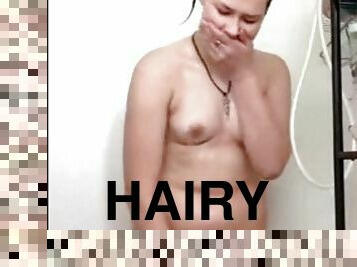 Sweety playing with her hairy pussy in the bathroom