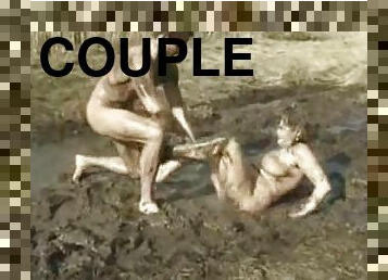 Muddy couple having fun doing each other showing how dirty they are