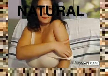Brunette posing her natural huge big tits on the webcam