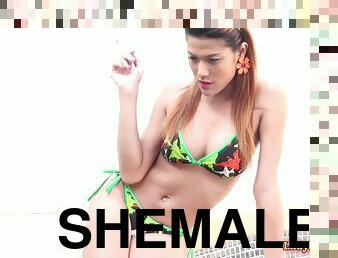 Thai shemale Lin smokes a cigarette outdoor by the swimming pool