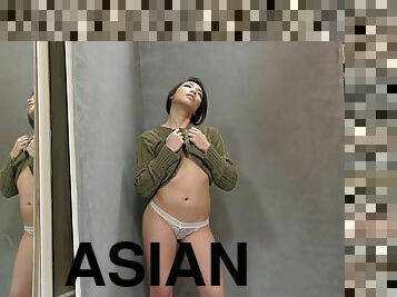 Asian lifts her sweater to show off her natural tits