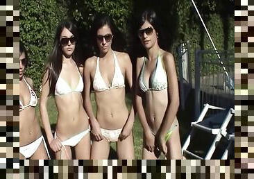 Four gorgeous teens having a bikini party in the back yard