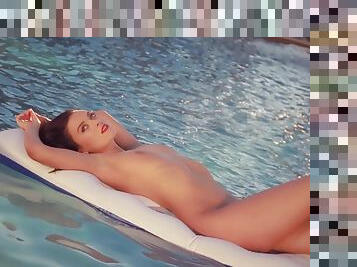 Centerfold Alexandra Tyler floats in the pool and teases you