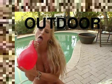 Long haired Brooke Belle plays with ballon and fetish in outdoor clip