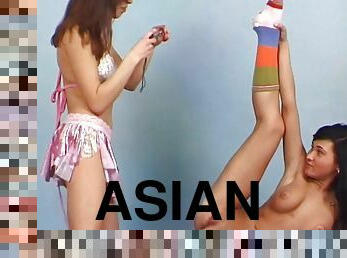 Asian lesbian shares a long dildo with her cute girlfriend