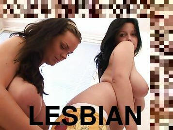 Two well-endowed lesbians play with each other's awesome tits