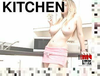 Long haired babe messes with food on big tits in kitchen solo scene