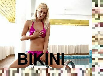 Blonde chick Briget looks amazing in a shiny pink bikini