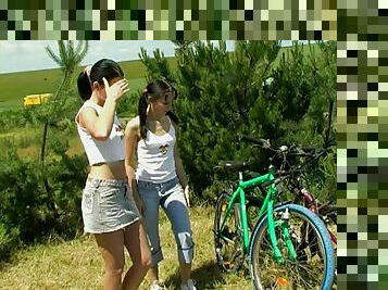Naughty teen lesbians take time off their bike rides for an outdoors pussy toying session