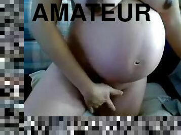 Nude pregnant girl posing on camera
