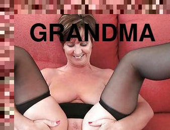 Classy grandma in stockings shows her big tits and pussy
