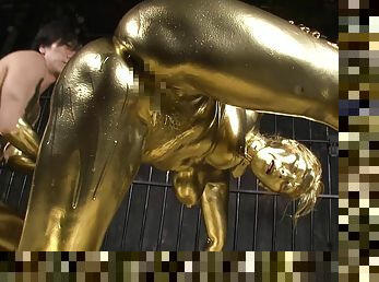 She is covered in gold paint then she gets fucked by a golden guy