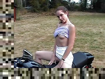 Slim teen hottie plays with her pussy on a motorcycle