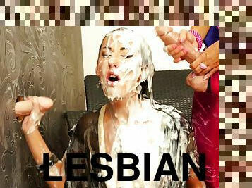Two tanned lesbians mess up with cream and get their faces covered through gloryhole