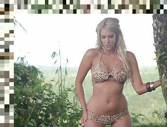 Blonde in a leopard print bikini plays at a mountain resort