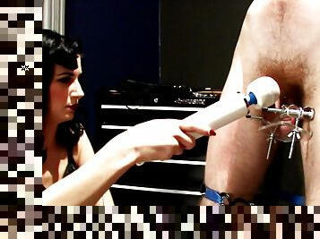 Mistress teases tortured slave's cock with a wand vibrator