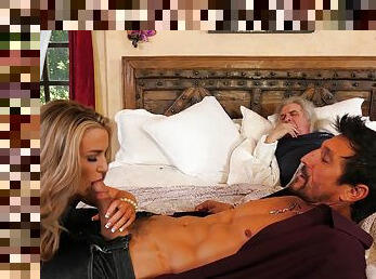 Blonde woman sucks man's dick with hubby sleeping next to them