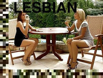 Gorgeous lesbians enjoy some wine and some outdoor pussy licking