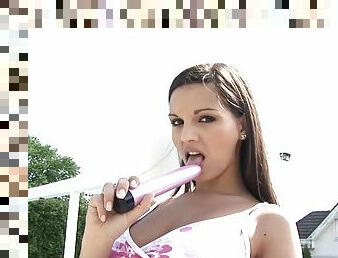 Outside by the pool this hot brunette hammers her hole with a toy