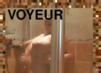 Spy captures a curvy girl taking a shower