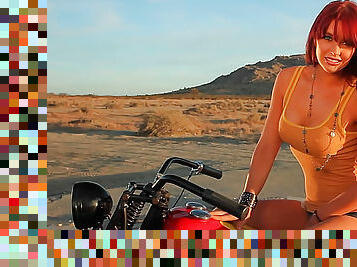 Redhead topless on a motorcycle