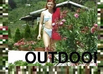 Redhead enjoys the warm sun as she bounces on a cock outdoors