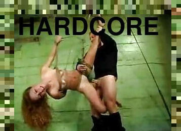 Redhead in extensive bondage is fucked