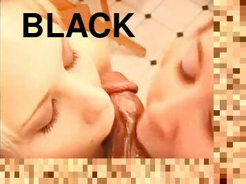 Two girls on their knees suck black cock