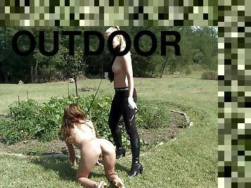 Female slave Dona Bell tied up in outdoors and spanked by a slut