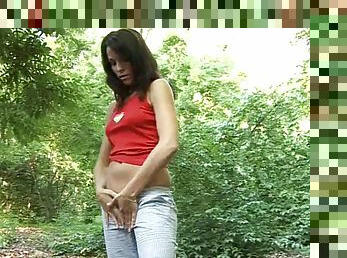 Impressively hot brunette takes off her jeans and anal toys outdoors