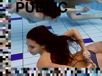 Cheerful naked girls are naughty in the pool