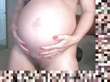 Pregnant girl in glasses does webcam show