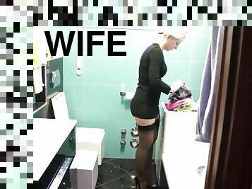 Housewife in nylon stockings preparing for the arrival of her husband