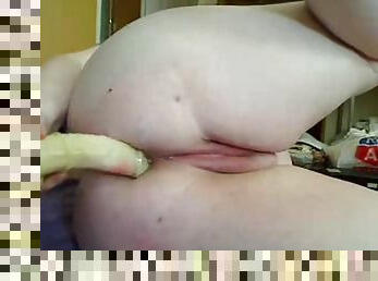 Fatty milf pleasures her ass with a big dildo.