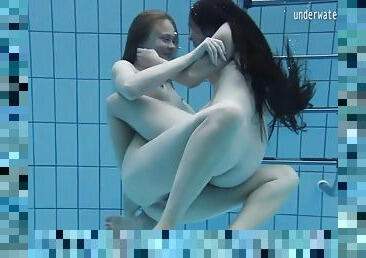 Cute girls fool around naked in the pool