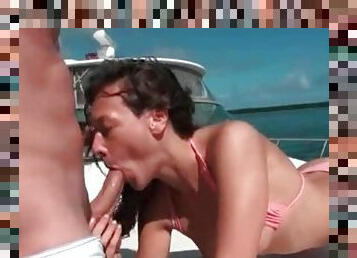 Bikini brunette sucks cock and fucks on a boat