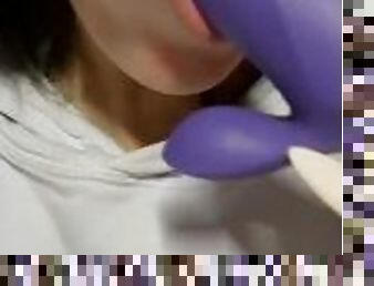 Pretty girl sucking a purple dildo