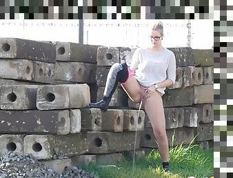 Sweater and tights on chick pissing outdoors