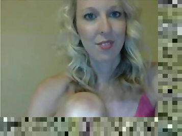 Sexy blonde milf on phone chatting and stripteasing in front of webcam
