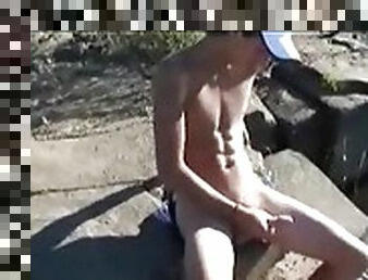 Adorable twink masturbating by the lake