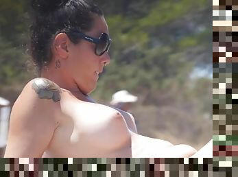 Tattooed babe at the beach has perfect big tits