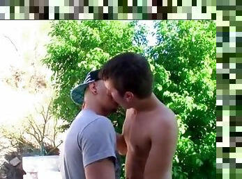 Boys kissing outdoors are full of passion