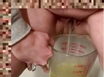 Pissing in a measuring cup