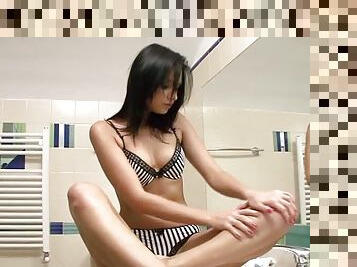 Naughty brunette girl masturbates sitting on a sink