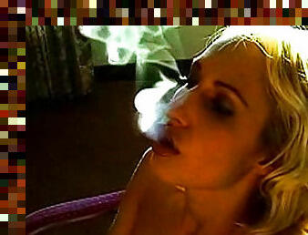 Smoking girl smiles in erotic video