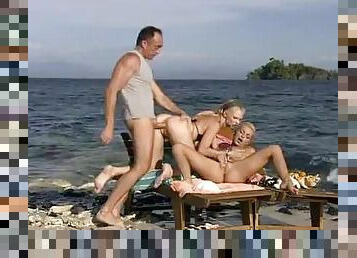 Two Blonde Hotties Take Over a Horny Guy at the Beach