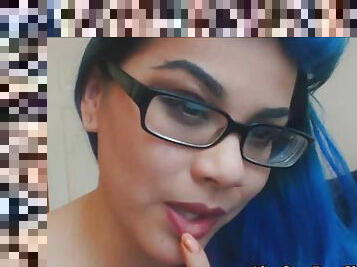 Teen with blue hair,glasses and tattooes making a video for money on webcam.