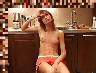 Slender teen naked in her kitchen
